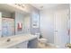 Well-lit bathroom with a single vanity, toilet, shower with curtain, and functional design at 4146 Mcever Park Dr, Acworth, GA 30101