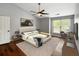 A stylish bedroom with a ceiling fan, work desk, and a cozy bed with a padded headboard at 4146 Mcever Park Dr, Acworth, GA 30101