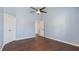 Open bedroom with hardwood floors, a ceiling fan, and multiple doors for easy access at 4146 Mcever Park Dr, Acworth, GA 30101