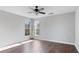 Light-filled bedroom featuring hardwood floors, ceiling fan, and two large windows for natural light at 4146 Mcever Park Dr, Acworth, GA 30101