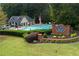 Beautiful community pool area with lounge chairs, lush landscaping, and a welcoming sign, ideal for relaxation and recreation at 4146 Mcever Park Dr, Acworth, GA 30101