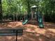 Community playground with swings, slides, and monkey bars in a wood chip safety area at 4146 Mcever Park Dr, Acworth, GA 30101