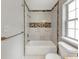 Tiled shower and tub combination in a bathroom with modern fixtures and natural light at 713 S Fairfield Dr, Peachtree City, GA 30269
