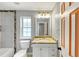 Bright bathroom featuring granite countertops, a window and decorative tile accents at 713 S Fairfield Dr, Peachtree City, GA 30269