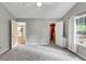 Bright bedroom featuring plush carpet, a closet, and natural light from a window at 713 S Fairfield Dr, Peachtree City, GA 30269