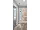 Bright foyer featuring wood floors, a decorative front door, and freshly painted walls at 713 S Fairfield Dr, Peachtree City, GA 30269