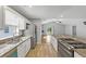 Bright kitchen view to stainless appliances, granite countertops and open concept to living room at 713 S Fairfield Dr, Peachtree City, GA 30269