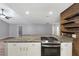 Kitchen island featuring granite countertops, stainless appliances, and decorative backsplash at 713 S Fairfield Dr, Peachtree City, GA 30269