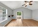 Bright living room featuring wood floors, high ceilings, and sliding glass doors to the back patio at 713 S Fairfield Dr, Peachtree City, GA 30269