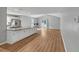 Open concept kitchen and living area with stainless appliances, large island and wood floors at 713 S Fairfield Dr, Peachtree City, GA 30269