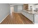 View of foyer from living area with wood floors leading to modern kitchen with island at 713 S Fairfield Dr, Peachtree City, GA 30269