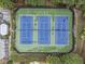 Aerial view of tennis courts showcasing blue courts, green exterior and surrounding landscape at 892 Gramercy Hills Ln, Mableton, GA 30126