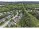 Aerial view showcases a residential community nestled amidst lush greenery and mature trees at 892 Gramercy Hills Ln, Mableton, GA 30126