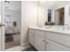 Bright bathroom with a double sink vanity and view of the bedroom and walk-in closet at 892 Gramercy Hills Ln, Mableton, GA 30126