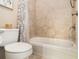Well-lit bathroom featuring a tiled shower/tub and a modern toilet for comfort at 892 Gramercy Hills Ln, Mableton, GA 30126