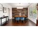 Elegant dining room features accent wall, modern lighting fixture, and large window at 892 Gramercy Hills Ln, Mableton, GA 30126