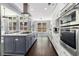 Open-concept kitchen boasts stainless steel appliances, large island, ample cabinet space, and modern finishes at 892 Gramercy Hills Ln, Mableton, GA 30126