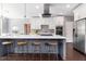 Beautiful kitchen featuring an island with seating, white cabinets, stainless steel appliances, and sleek countertops at 892 Gramercy Hills Ln, Mableton, GA 30126