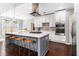 Modern kitchen featuring a large center island, stainless steel appliances, and updated lighting at 892 Gramercy Hills Ln, Mableton, GA 30126
