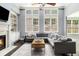 Bright living room with a fireplace, built-in shelves, tall windows, and comfortable seating area at 892 Gramercy Hills Ln, Mableton, GA 30126