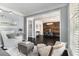 Open concept living room showcases hardwood floors, modern decor, and seamless flow to the dining area at 892 Gramercy Hills Ln, Mableton, GA 30126