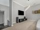 Open living room features wall-mounted TV with modern entertainment center and neutral carpet at 892 Gramercy Hills Ln, Mableton, GA 30126