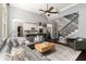 Stylish living space with an open-concept kitchen, staircase and comfortable seating area at 892 Gramercy Hills Ln, Mableton, GA 30126