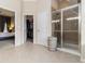 Bright main bathroom features a glass shower, tile flooring, and an entrance to the bedroom at 892 Gramercy Hills Ln, Mableton, GA 30126