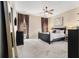Comfortable main bedroom featuring a ceiling fan, stylish furniture, and ample natural light, ideal for relaxation at 892 Gramercy Hills Ln, Mableton, GA 30126