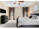 Spacious main bedroom with plush carpeting, a ceiling fan, and natural light from two windows at 892 Gramercy Hills Ln, Mableton, GA 30126