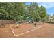 Community playground with slides, swings, and a seesaw surrounded by lush trees at 892 Gramercy Hills Ln, Mableton, GA 30126