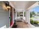 Inviting front porch with swing seating, brick flooring, and exterior lighting at 892 Gramercy Hills Ln, Mableton, GA 30126