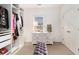 Well-organized walk-in closet with custom shelving, ample storage, and a cozy bench at 892 Gramercy Hills Ln, Mableton, GA 30126