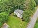 Aerial view of a home with large yard, mature trees, two story porch, and adjacent to the street at 1160 Foster Nw Pl, Atlanta, GA 30318