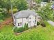 Aerial view showcasing a home with a gray roof and green yard, surrounded by mature trees at 1160 Foster Nw Pl, Atlanta, GA 30318