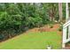 Large backyard features lush grass and trees; includes a baseball practice net at 1160 Foster Nw Pl, Atlanta, GA 30318