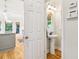 Half bathroom with pedestal sink, hardwood floors and is located off the kitchen at 1160 Foster Nw Pl, Atlanta, GA 30318