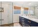 Modern bathroom with double vanity, glass shower, and wood floors at 1160 Foster Nw Pl, Atlanta, GA 30318