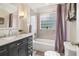Well-lit bathroom features vanity and tub-shower combo at 1160 Foster Nw Pl, Atlanta, GA 30318