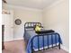 Well-lit bedroom with blue bedspread, iron bed frame, and a dark wooden dresser at 1160 Foster Nw Pl, Atlanta, GA 30318
