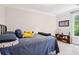 Comfortable bedroom with a quilted blue bedspread and a decorative shelf with trophies at 1160 Foster Nw Pl, Atlanta, GA 30318