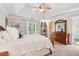 Spacious bedroom features tray ceilings, ceiling fan, balcony access, and furniture at 1160 Foster Nw Pl, Atlanta, GA 30318
