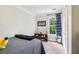 Comfortable bedroom featuring a shelf with trophies, closet, and window with curtains at 1160 Foster Nw Pl, Atlanta, GA 30318
