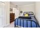 Well-lit bedroom with blue bedspread, iron bed frame, and a dark wooden dresser at 1160 Foster Nw Pl, Atlanta, GA 30318