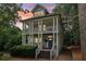 Charming two-story home with a double porch, stately columns, and a well-maintained front yard with an orange sky at 1160 Foster Nw Pl, Atlanta, GA 30318