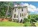 Spacious home with a front yard, lush landscaping, and mature trees at 1160 Foster Nw Pl, Atlanta, GA 30318