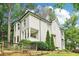 Elegant home with light siding, dark trim, and beautiful landscaping at 1160 Foster Nw Pl, Atlanta, GA 30318