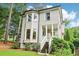 Two-story home with inviting front porch and lush greenery in a picturesque setting at 1160 Foster Nw Pl, Atlanta, GA 30318