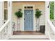 Charming front porch featuring a blue door, perfect for enjoying the outdoors and neighborhood views at 1160 Foster Nw Pl, Atlanta, GA 30318