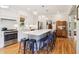 Bright and open kitchen features large island, pendant lighting, and stainless appliances at 1160 Foster Nw Pl, Atlanta, GA 30318